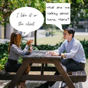 man and woman talking at a picnic table